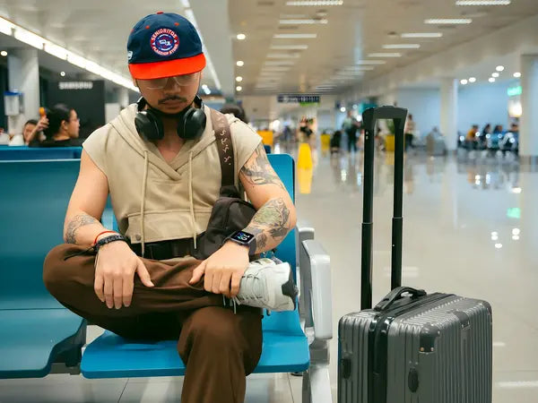 A man at an airport wearing The Trevit Smartwatch
