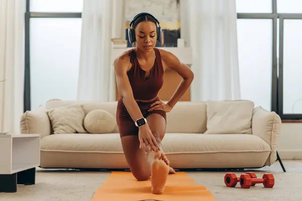 A lady working out at home wearing The Trevit Smartwatch