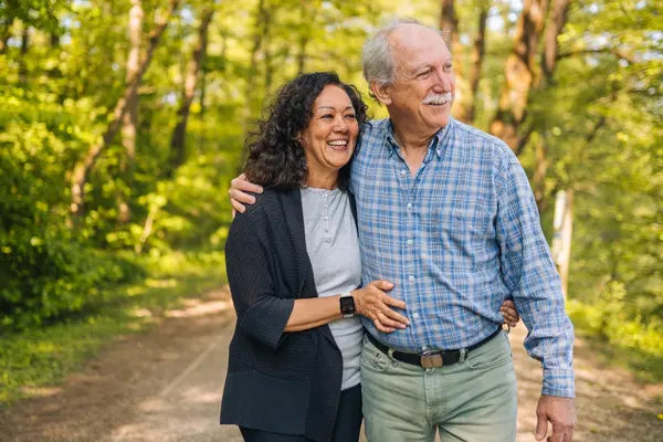 An elderly couple strolling, with the lady wearing The Trevit Smartwatch
